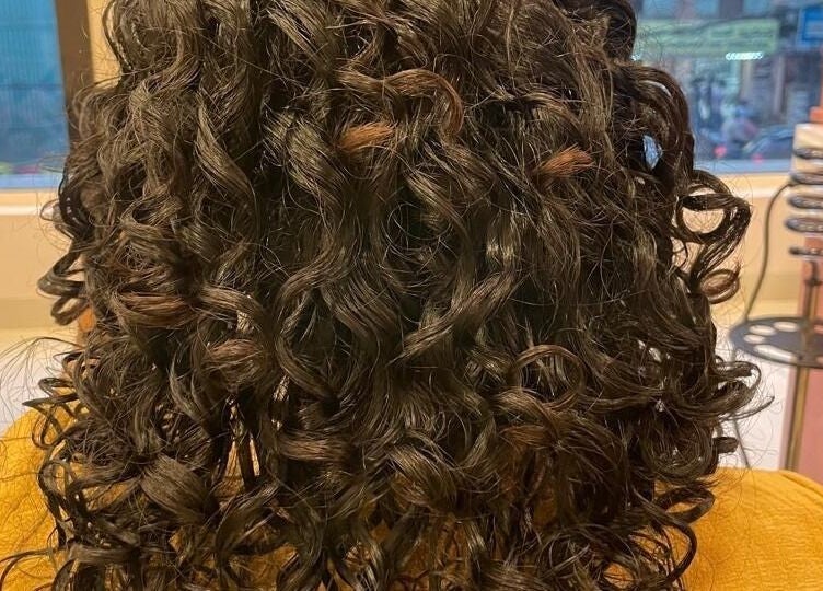 Lush curly hair treatment at Care Wellness Bangalore, Bengaluru, Karnataka, IN, showcasing vibrant styling.