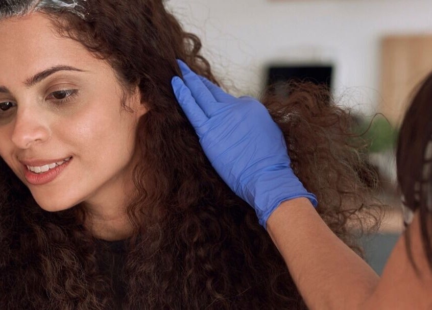 Woman enjoying hair treatment at Care Wellness Bangalore in Bengaluru, Karnataka, IN.