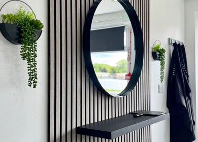 Modern mirror and plants at Hairfinity By Kelly, Wyton, England, GB creating a stylish and inviting ambiance.