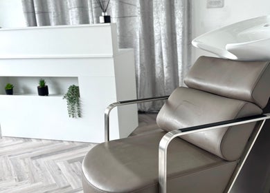 Modern salon chair and sleek decor at Hairfinity By Kelly, located in Wyton, England, GB.