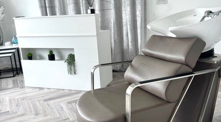 Modern salon chair and sleek decor at Hairfinity By Kelly, located in Wyton, England, GB.
