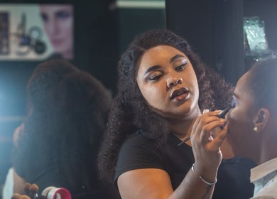 Makeup artist skillfully applying eyeshadow at Beautify By Omie in Willemstad, Curaçao, CW.