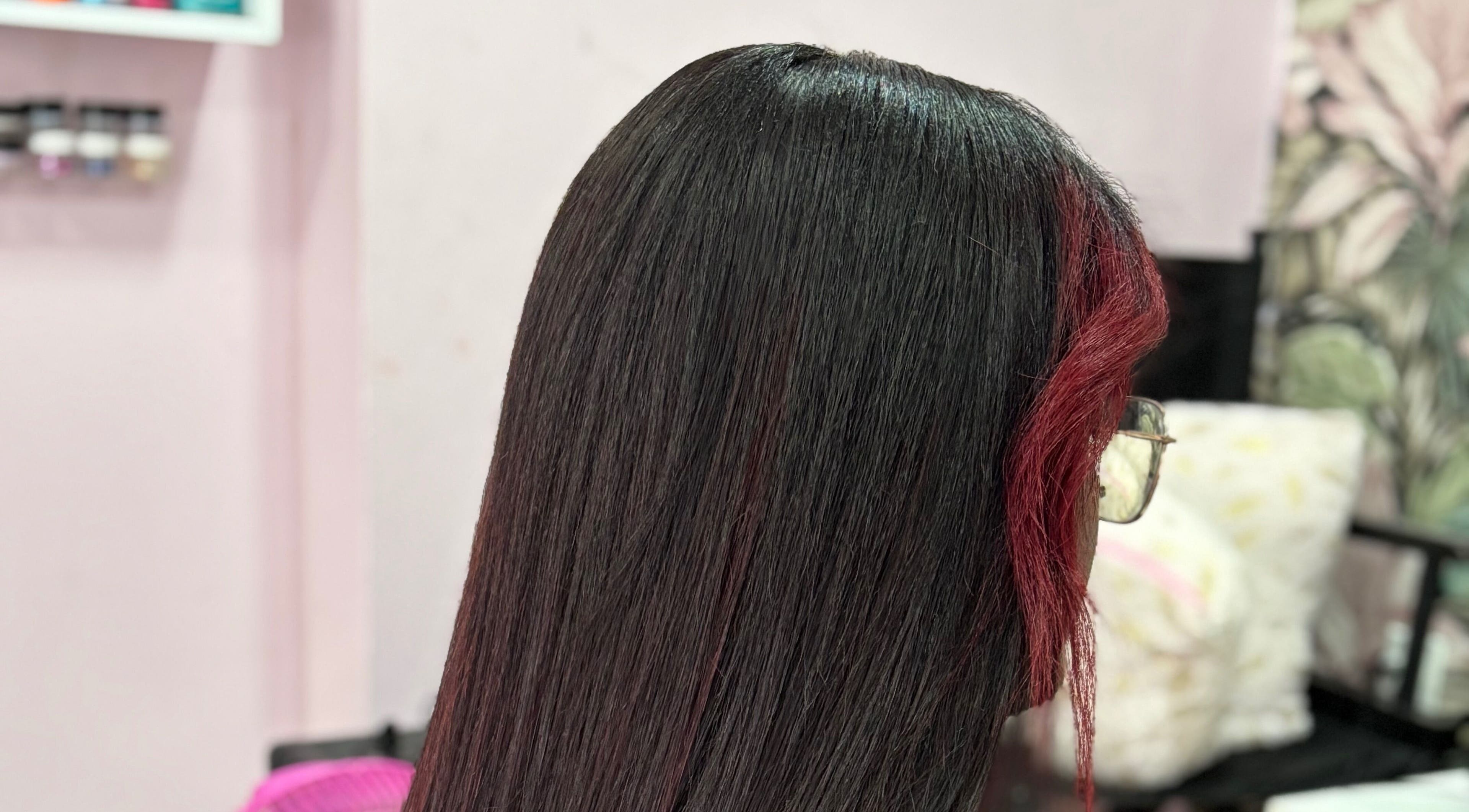 Elegant hair styling at Beautify By Omie, Willemstad, Curaçao, CW showcasing smooth, straight hair finish.