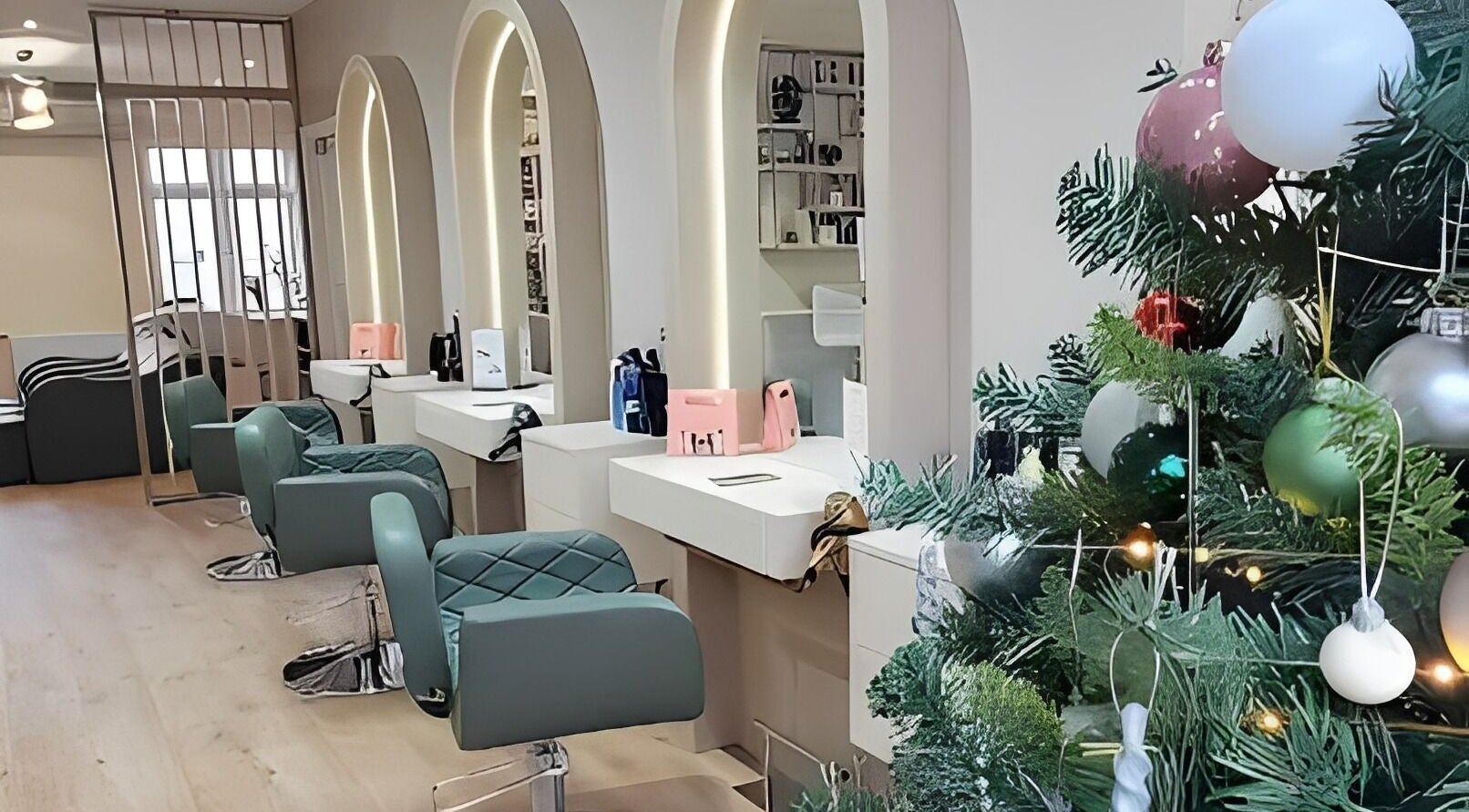 Modern salon interior at Loca HBH Ltd., Radlett, England, decorated with festive ornaments.