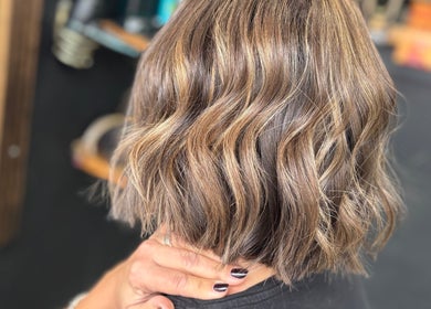 Stylish wavy haircut with highlights at Hair by Jodie at Efie in Cannock, England, GB.