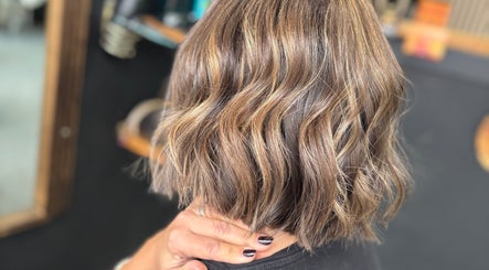 Stylish wavy haircut with highlights at Hair by Jodie at Efie in Cannock, England, GB.