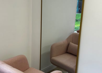 Elegant pink chair with a gold-framed mirror at Lvl by Gem, Bristol, England, GB.