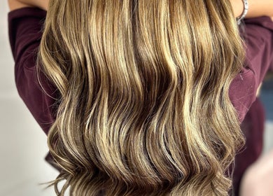 Elegant blonde waves styled at Lvl by Gem, Bristol, England, GB, showcasing textured, glossy hair.