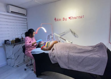 Aesthetician at SkinByGharnet in Lagos, Lagos, NG, performing a soothing facial treatment.