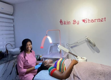 Therapist at SkinByGharnet in Lagos, Lagos, NG providing a soothing facial treatment to a client.
