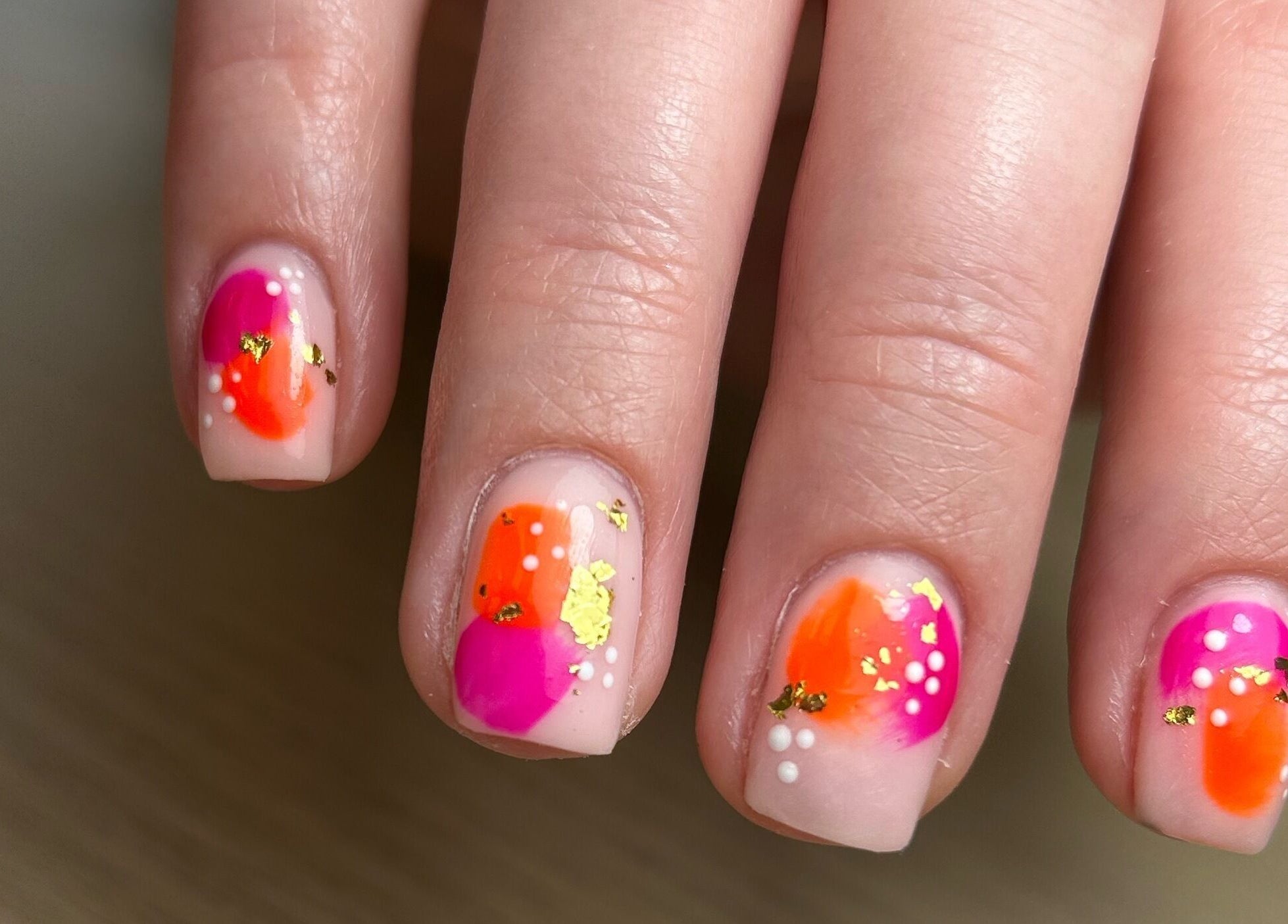 Artistic neon nail design at AdoreByChlo, Rugby, England, GB showcasing pink and orange hues.