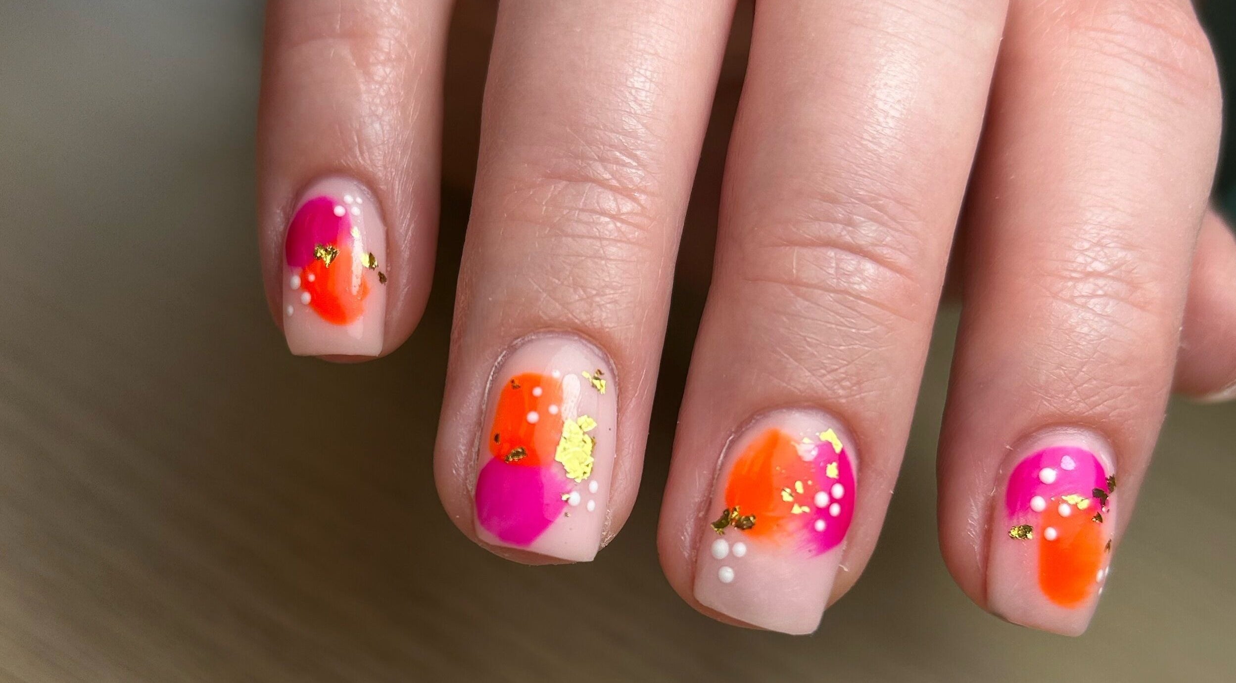 Artistic neon nail design at AdoreByChlo, Rugby, England, GB showcasing pink and orange hues.