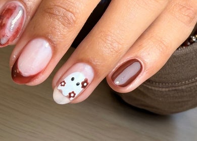 Elegant autumn-themed nail art at AdoreByChlo, Rugby, England, GB. Features brown tones and floral designs.