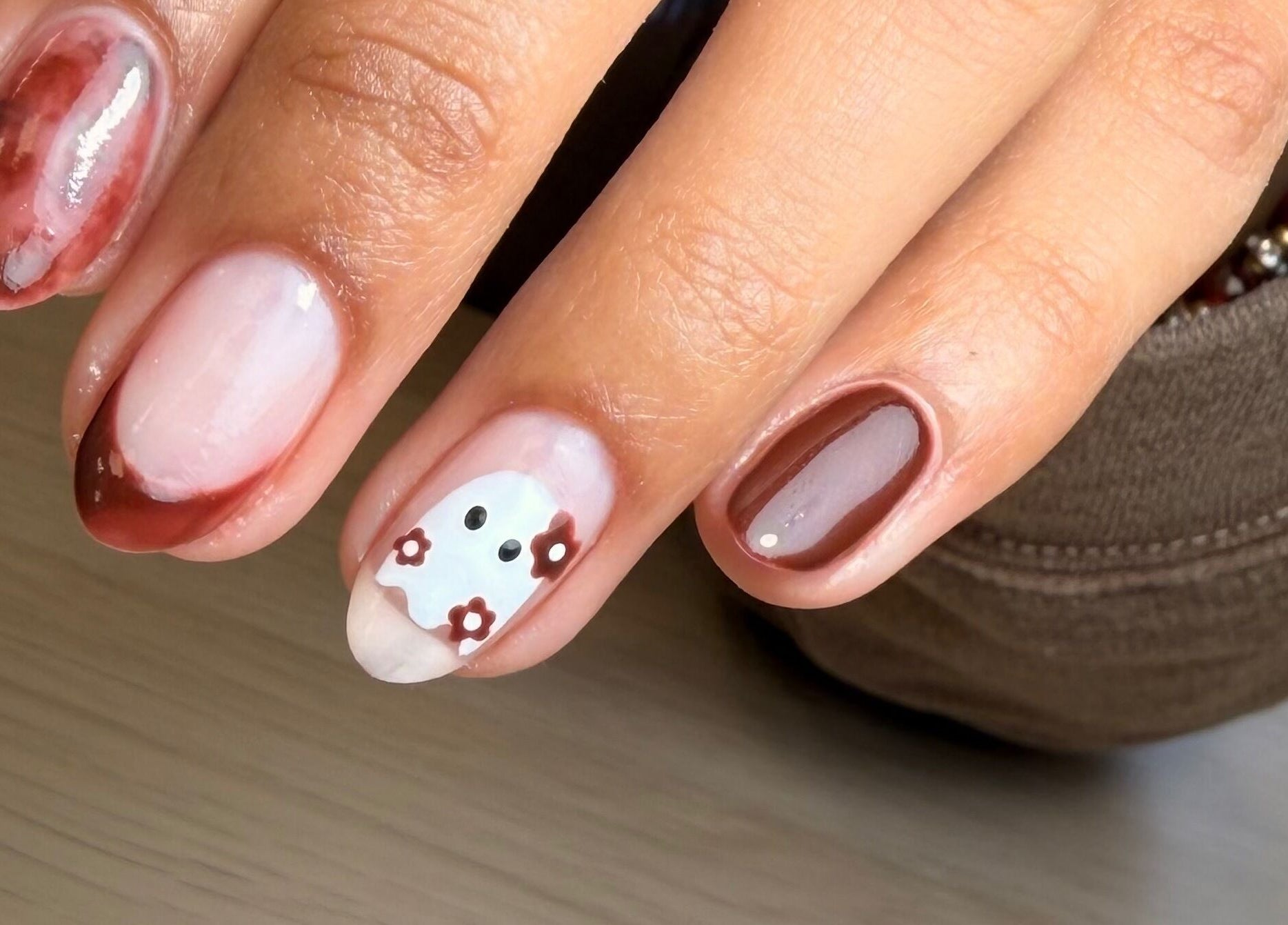 Elegant autumn-themed nail art at AdoreByChlo, Rugby, England, GB. Features brown tones and floral designs.