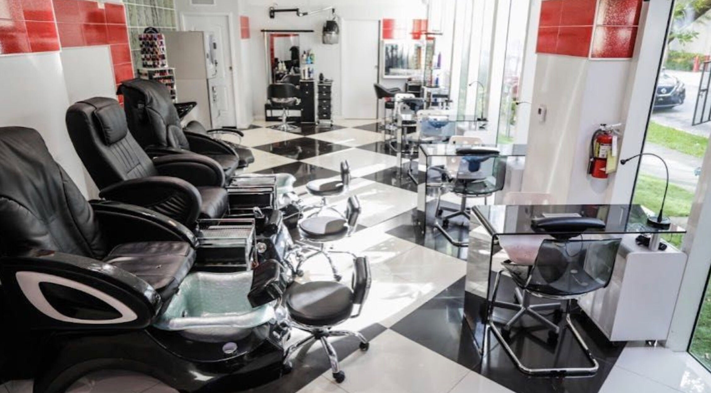 Modern interior of Salon As Hair in Miami, Florida, US, featuring sleek styling and manicure stations.