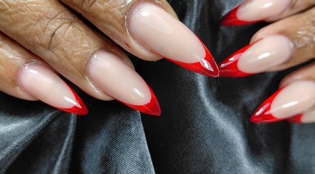 Stylish red-tipped nails at The Rich Brave Studio in Willemstad, Curaçao, CW.