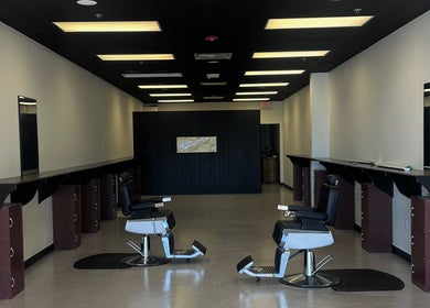 Modern interior of Upperroom Barbershop in Russellville, Arkansas, US with stylish barber chairs.