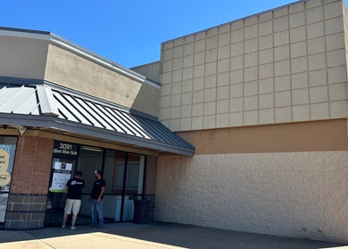 Front view of Upperroom Barbershop located in Russellville, Arkansas, US with clear blue sky.
