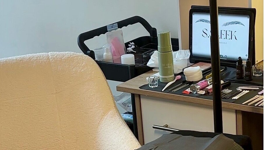 Beauty station at S.Sleek in Bolton, England, GB, showcasing tools and a cozy chair for treatments.