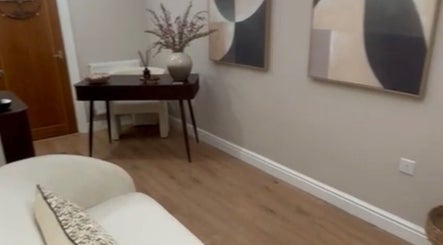 Contemporary decor at Mia's Beauty Room in Poole, England, GB. Elegant table and abstract wall art.