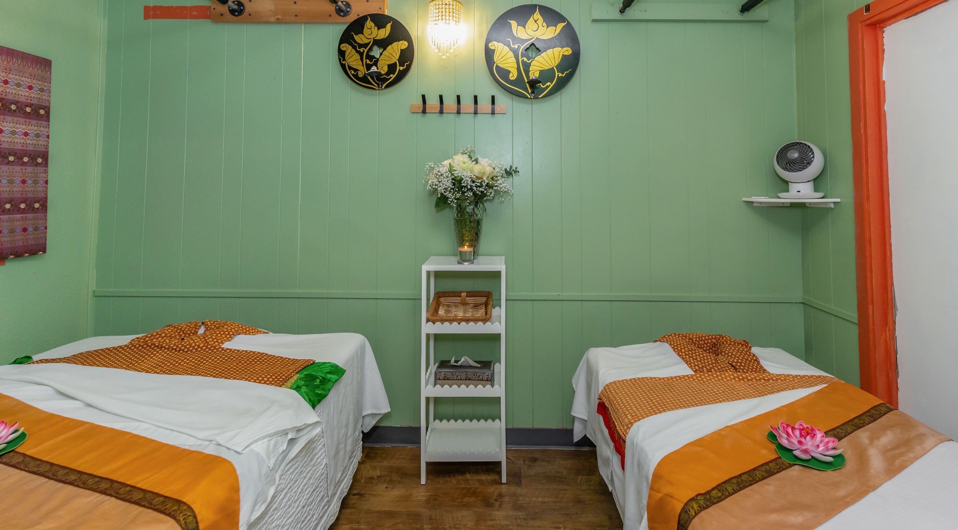 Tranquil massage room at Thai Style Massage in San Diego, California, US with green walls and elegant decor.