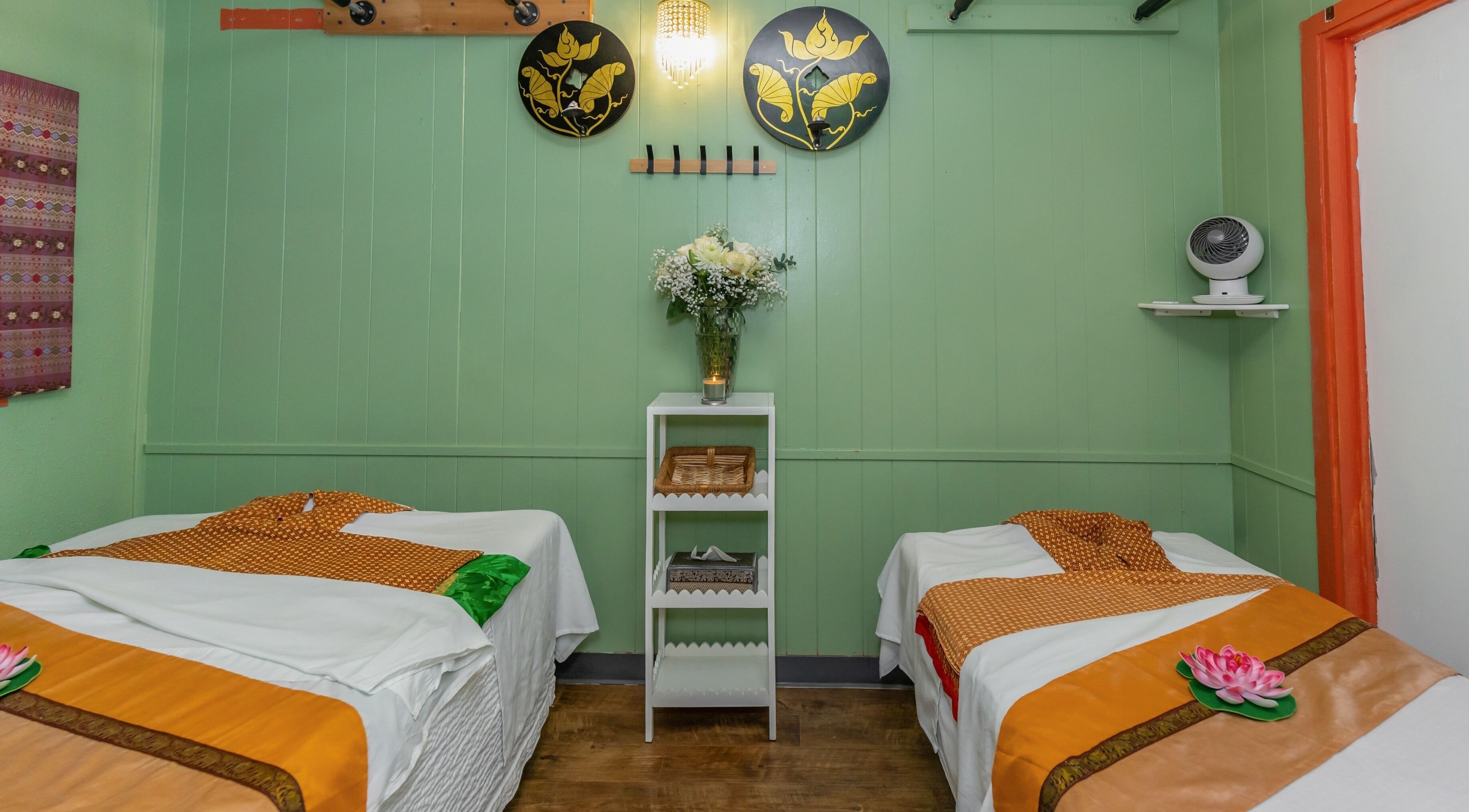 Tranquil massage room at Thai Style Massage in San Diego, California, US with green walls and elegant decor.