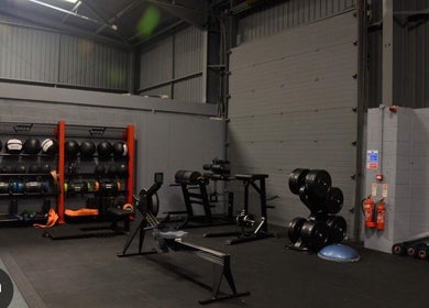 Modern gym at MK Coaching, Halfway, England, GB, showcasing diverse fitness equipment in a sleek setting.