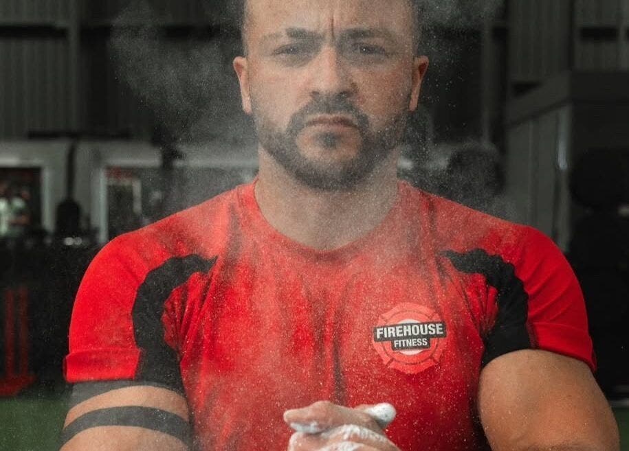 Person in red shirt at MK Coaching gym, Halfway, England, GB, preparing with focus.