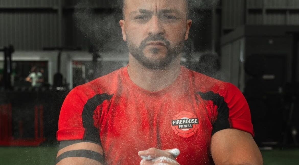 Person in red shirt at MK Coaching gym, Halfway, England, GB, preparing with focus.