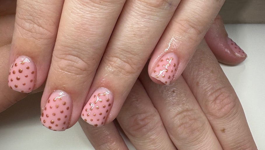 Elegant pink nail art with golden dots at Createdbycarris in Lytham Saint Annes, England, GB.