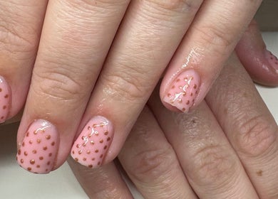 Elegant pink nail art with golden dots at Createdbycarris in Lytham Saint Annes, England, GB.