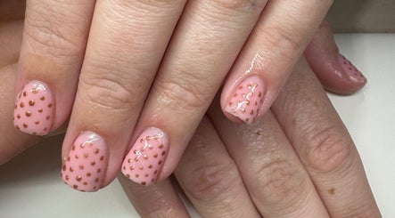 Elegant pink nail art with golden dots at Createdbycarris in Lytham Saint Annes, England, GB.