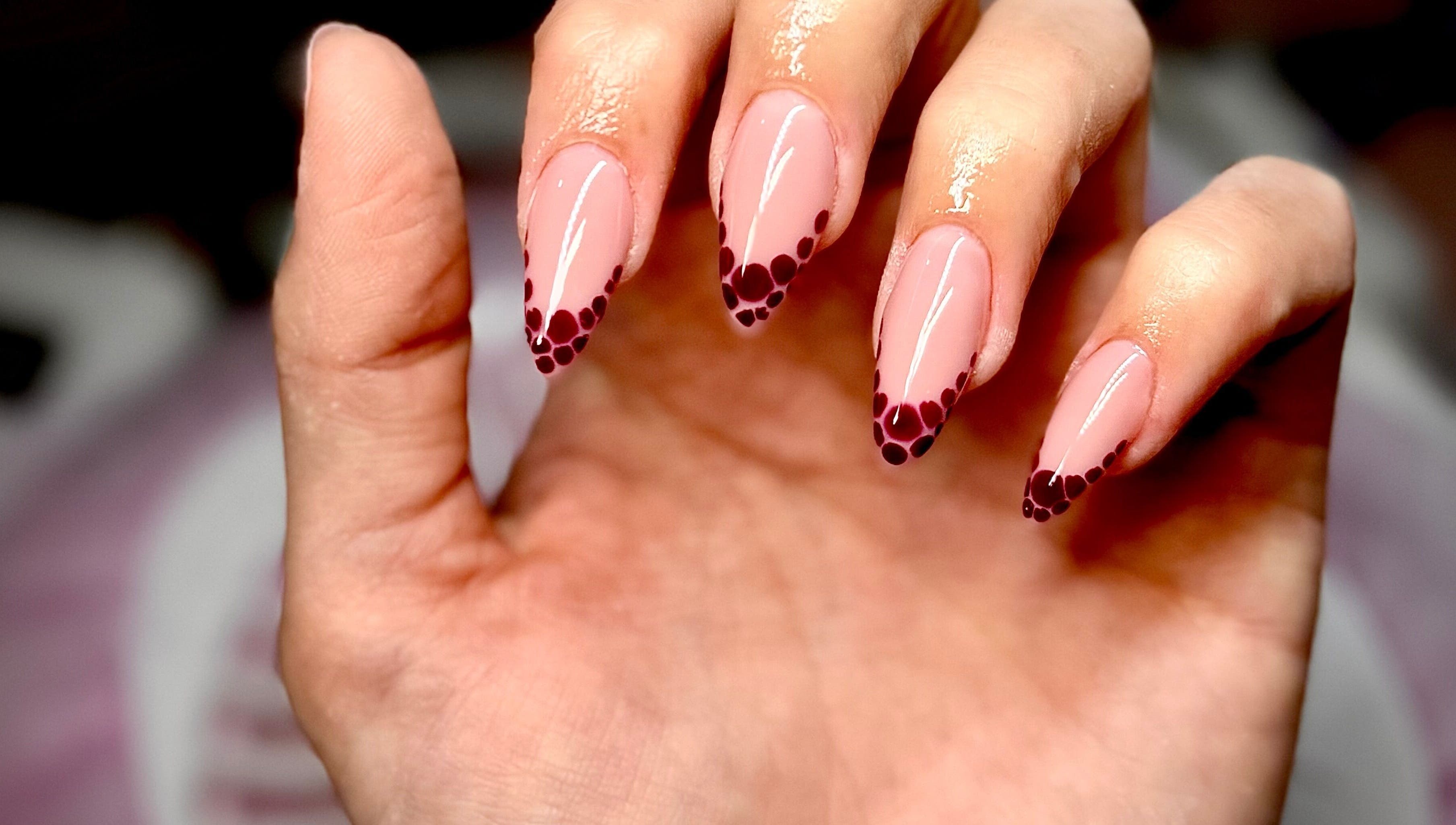 Stylish polka-dotted nail art at Nails by Klaudia, London, England, GB. Perfect for a chic look.