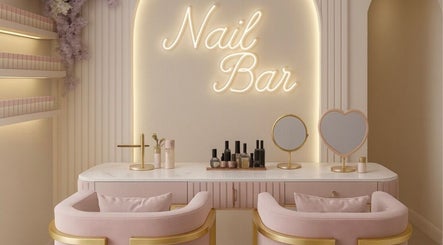 Chic nail bar at Maison Belissy, Toronto, Ontario, CA, featuring plush pink seating and gold accents.