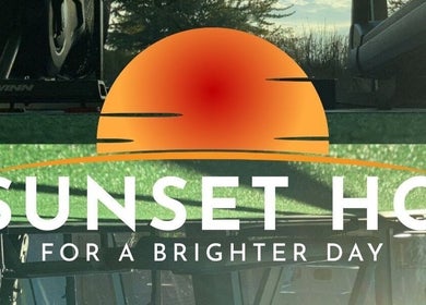 Modern gym interior at Goldman Personal Training in Richmond, BC, highlighting a bright sunset-themed decor.