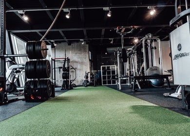 Modern gym at Goldman Personal Training, Richmond, BC, with equipment and green turf.