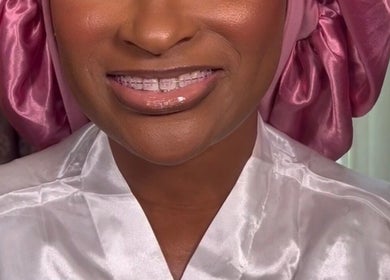 Smiling client in a satin robe at Pamper You Studio in Hueytown, Alabama, US, showcasing relaxation and beauty.