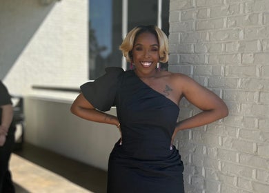 Elegantly dressed person smiling outside Pamper You Studio, Hueytown, Alabama, US.