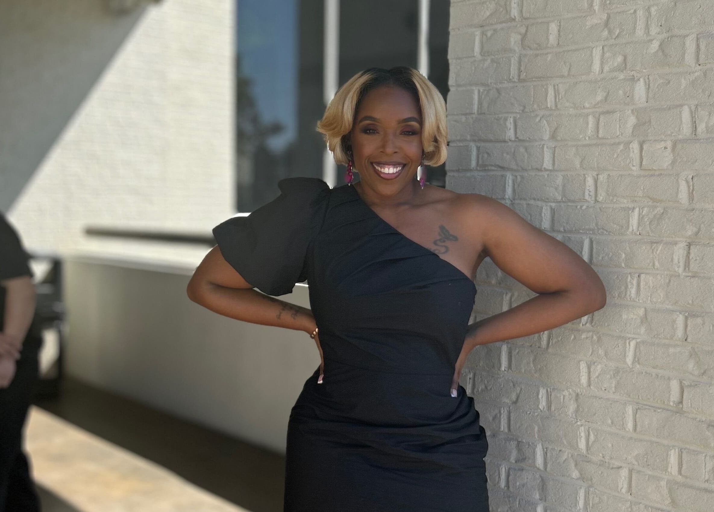 Elegantly dressed person smiling outside Pamper You Studio, Hueytown, Alabama, US.