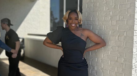 Elegantly dressed person smiling outside Pamper You Studio, Hueytown, Alabama, US.