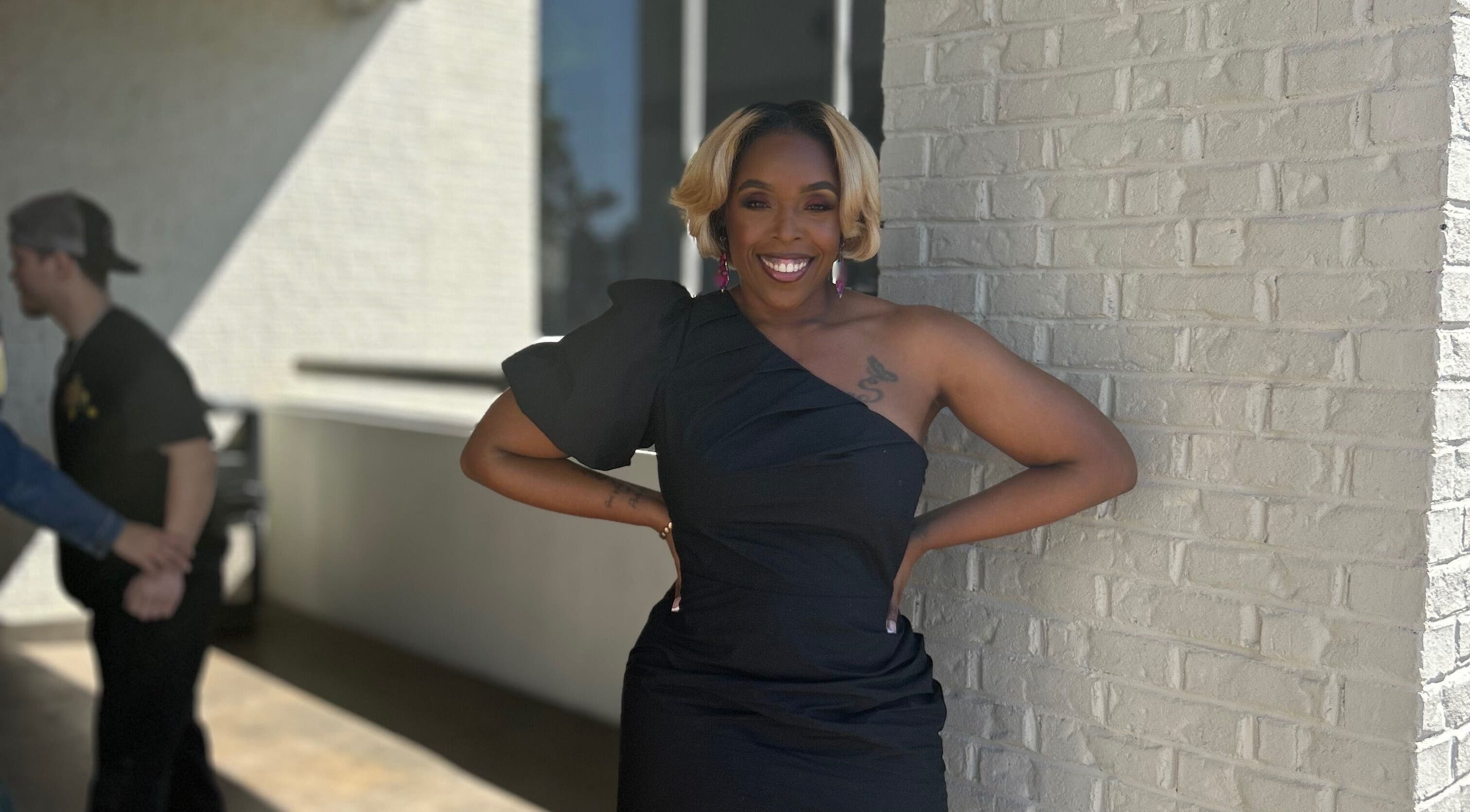 Elegantly dressed person smiling outside Pamper You Studio, Hueytown, Alabama, US.