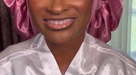 Woman in satin robe and pink scarf smiling at Pamper You Studio, Hueytown, Alabama, US.