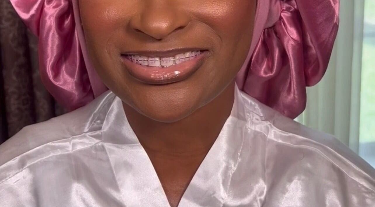 Woman in satin robe and pink scarf smiling at Pamper You Studio, Hueytown, Alabama, US.