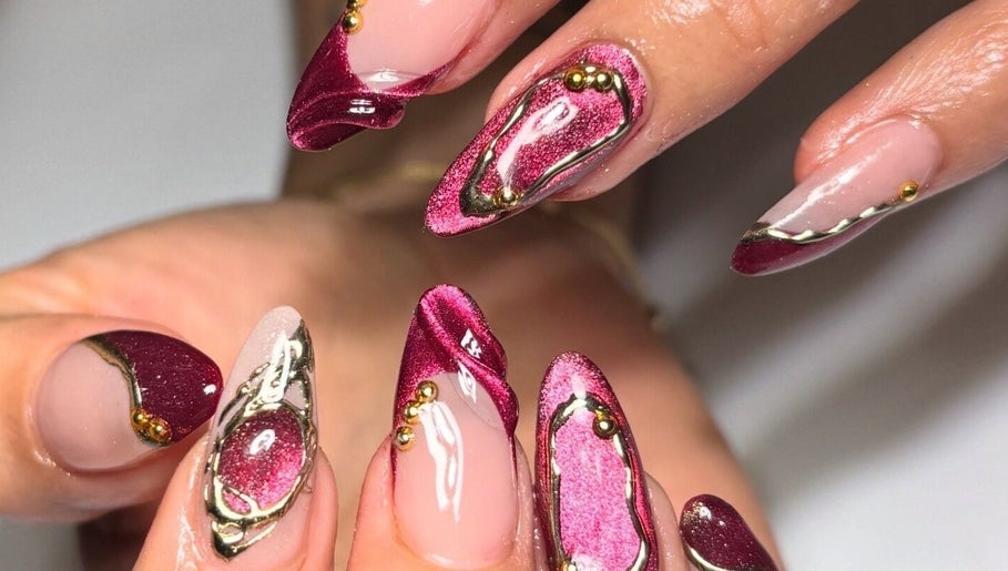 Elegant maroon and gold nail art at Polished Nail Bar DTLA, Los Angeles, California, US.