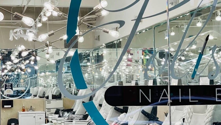 Modern interior of Polished Nail Bar DTLA, Los Angeles, California, US with mirrored walls and stylish lighting.