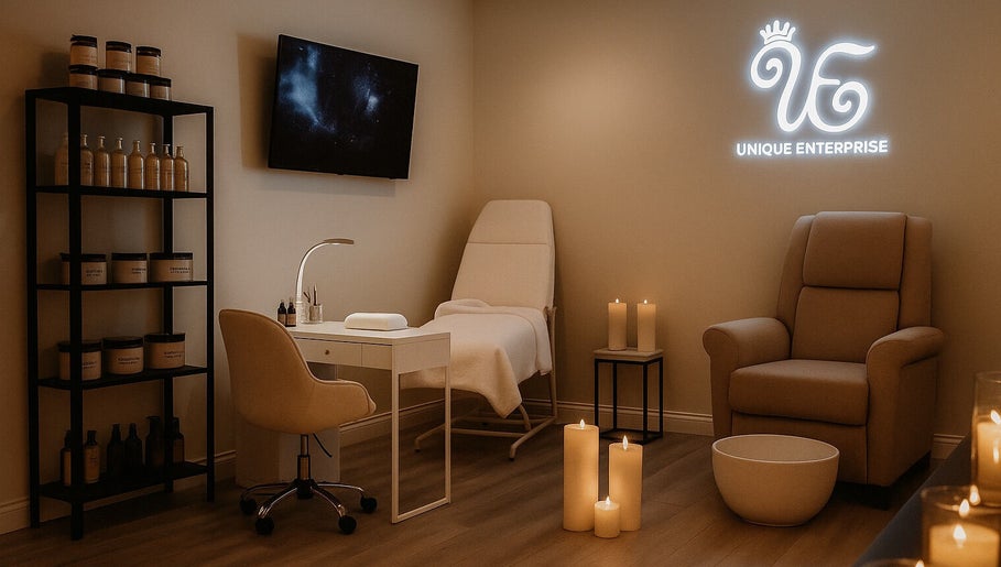 Elegant spa room at Unique Enterprise Nails, Atlanta, Georgia, US, with plush seating and ambient candles.