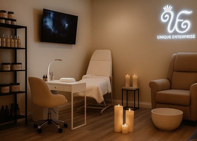 Elegant spa room at Unique Enterprise Nails, Atlanta, Georgia, US, with plush seating and ambient candles.