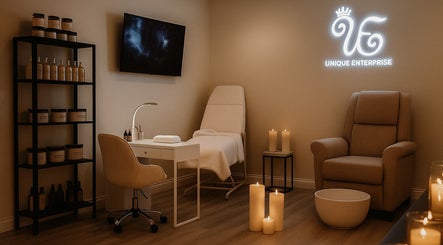 Elegant spa room at Unique Enterprise Nails, Atlanta, Georgia, US, with plush seating and ambient candles.
