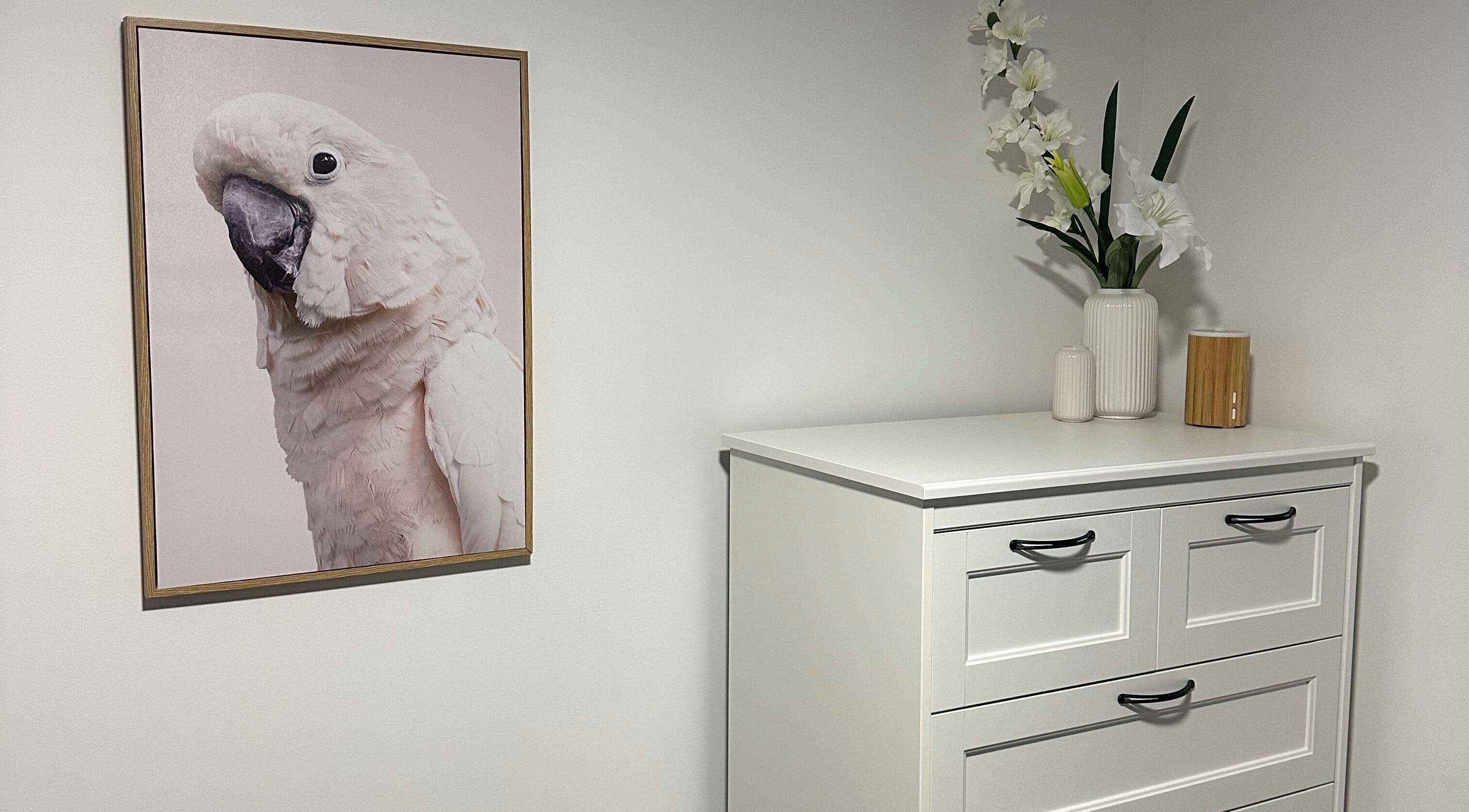 Bright cockatoo art and floral vase at Alter Beauty, Harristown, Queensland, AU.
