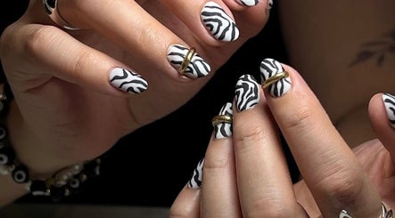 Stylish zebra print nails with gold accents at MAKOKI NAILS, Zapopan, Jalisco, MX.